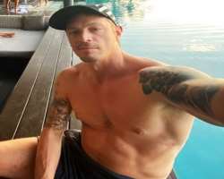 He has tattoos on both arms.
